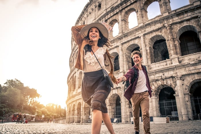 Italy, Rome, Colosseum, young couple running