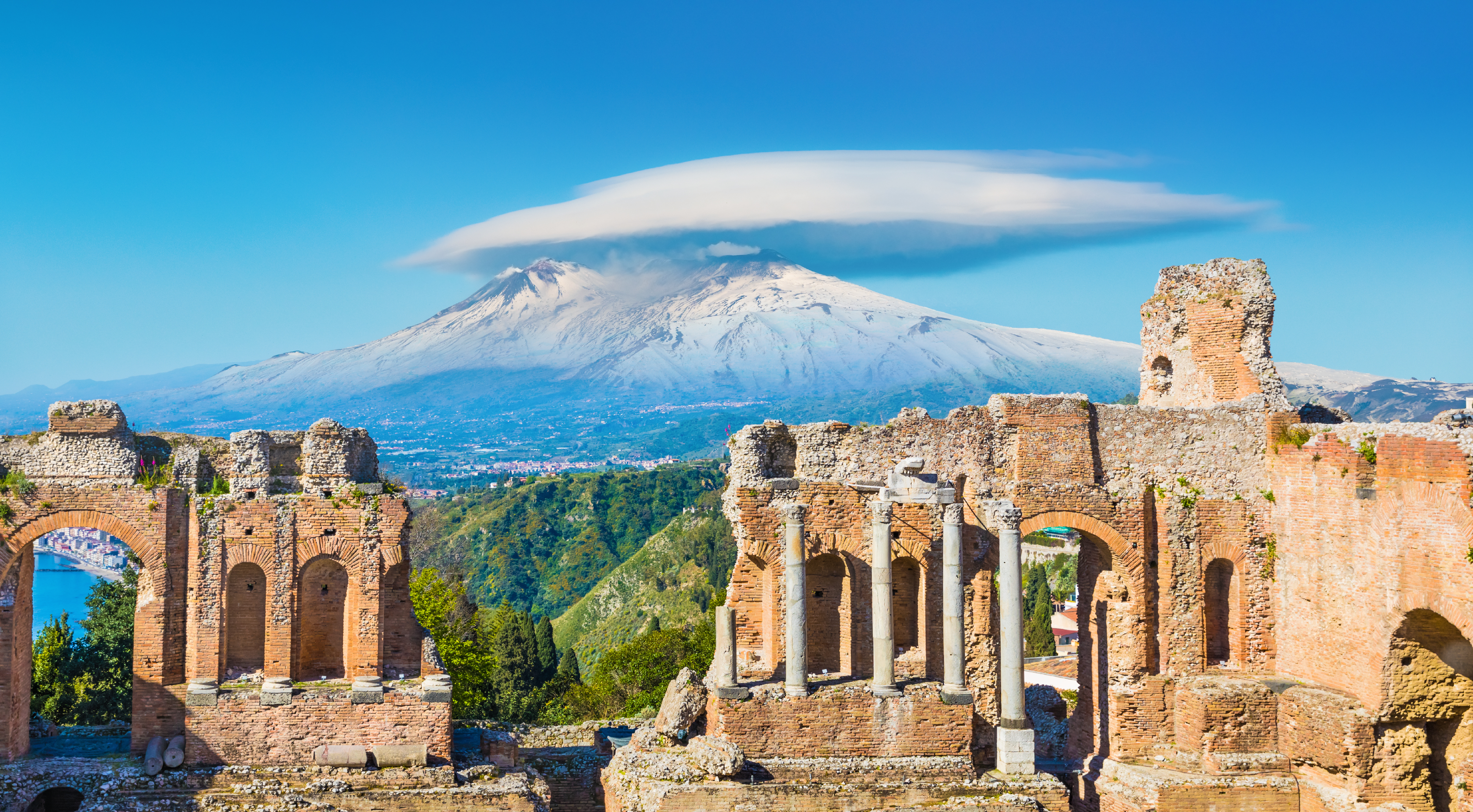 Taormina on background of Etna Volcano, Italy