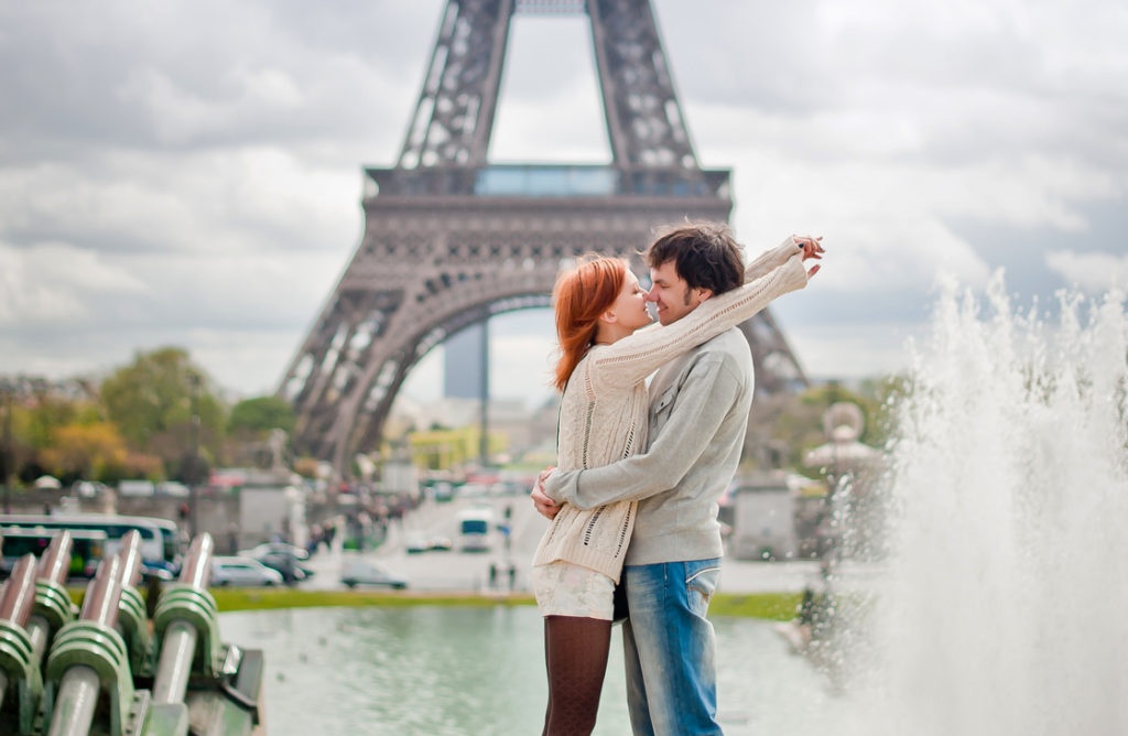 Lovers kissing in Paris with the Eiffel Tower in the Background