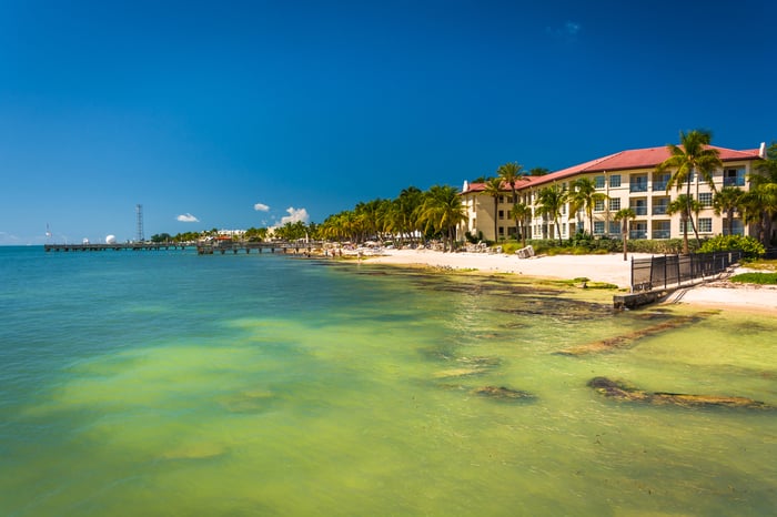 Turquoise waters of the Gulf of Mexico and buildings along the beach in Key West, Florida.